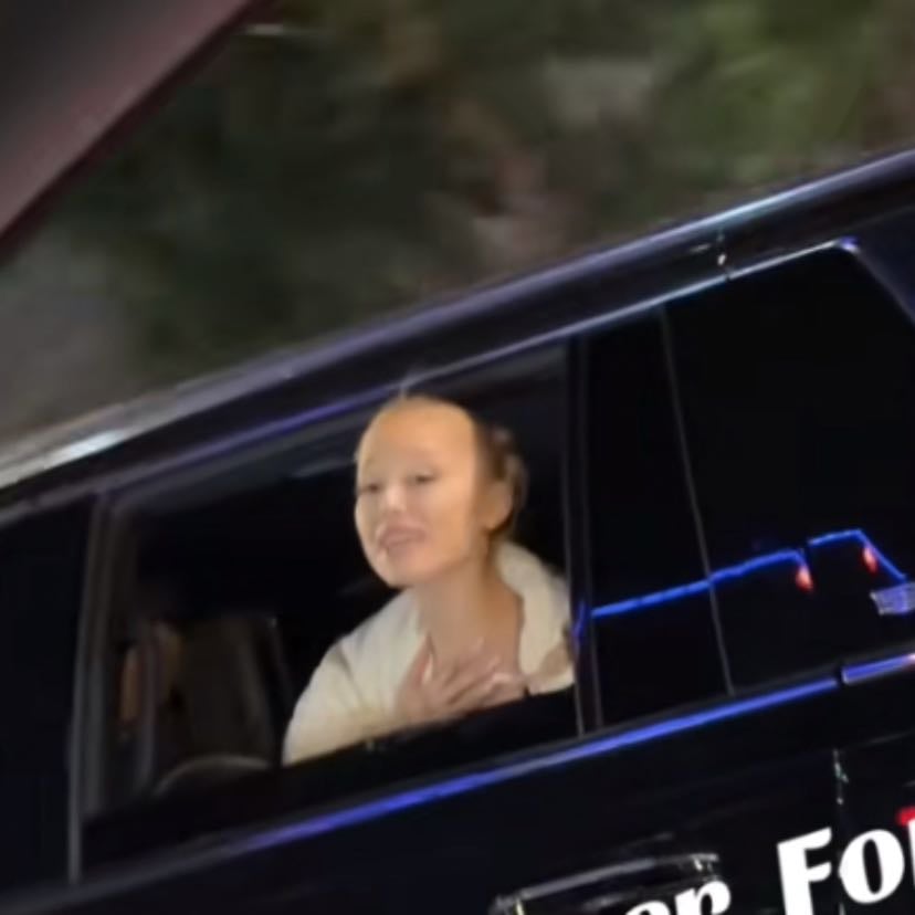 singing imagine with a fan through the car