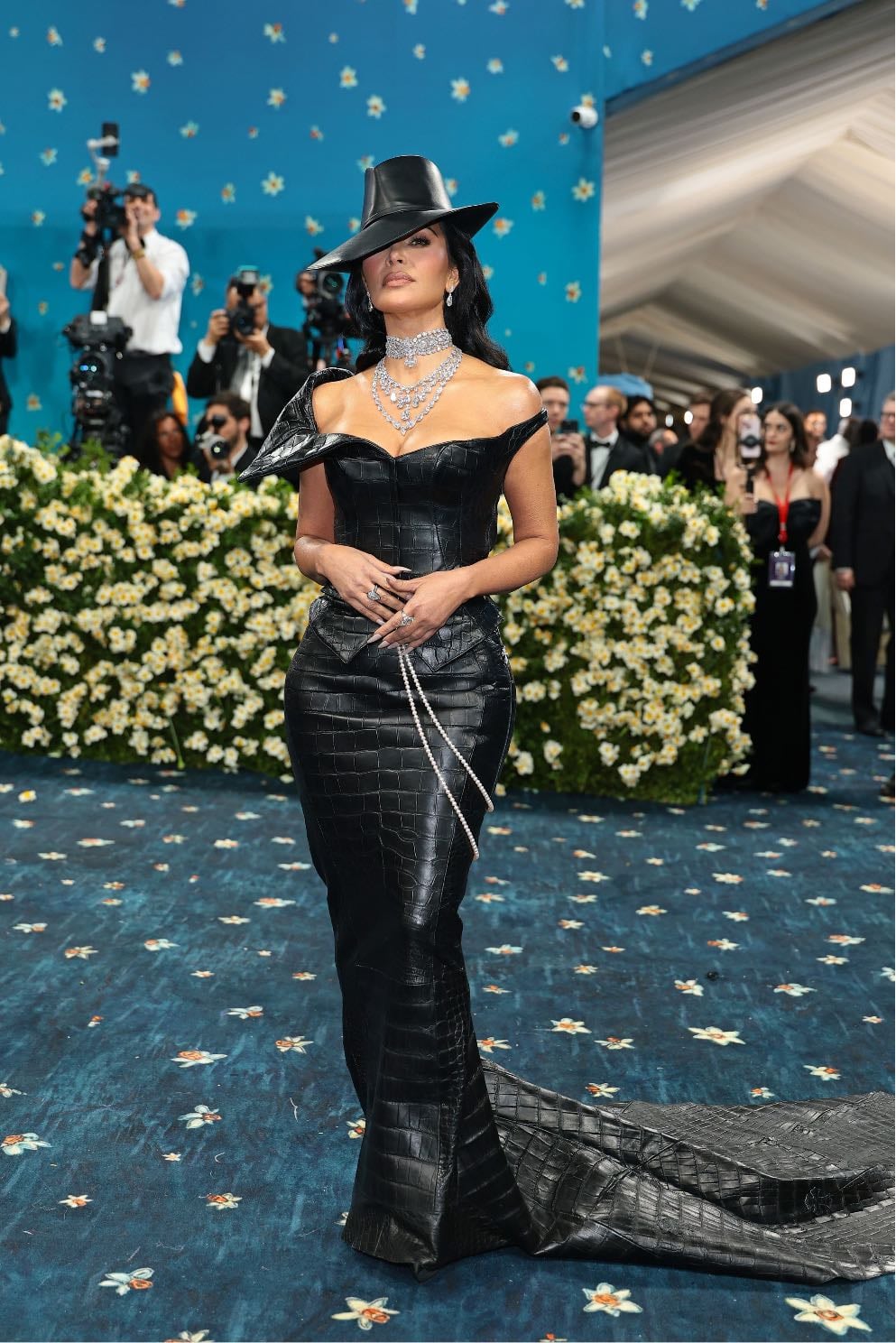 kim kardashian - custom chrome hearts
a black leather top and skirt, paired with a matching hat, a pearl belt and diamond jewellery
