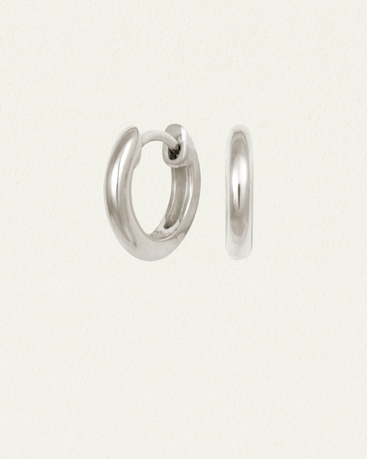 Omega Huggie Earrings Silver - The Omega Hoops in Ethical Sterling Silver carry the final letter of the Greek alphabet as their namesake. Thoughtfully designed by Temple of the Sun in Byron Bay.