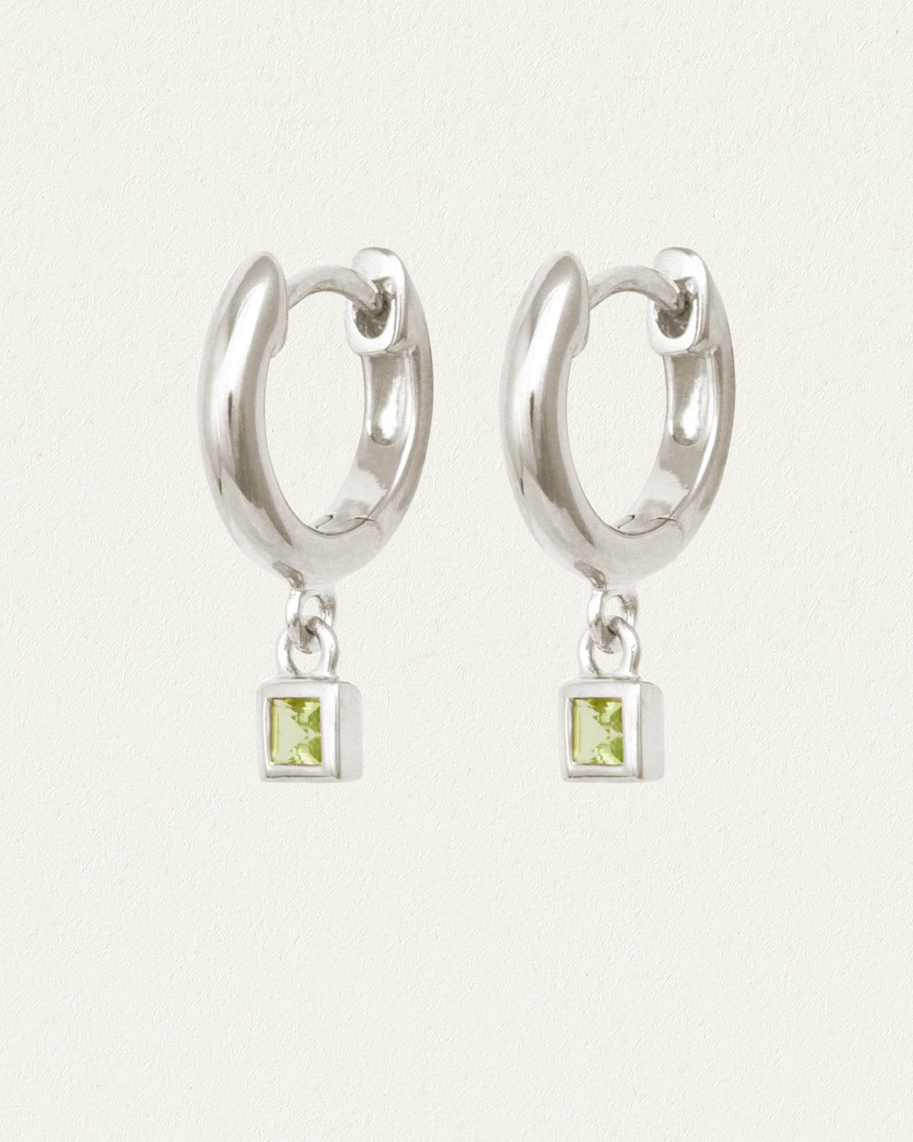 Hebe Huggies Silver - The Hebe Earrings in Ethical Sterling Silver feature princess cut Peridot drops. Shop thoughtfully designed gemstone huggies that embody eternal youth. From Temple of the Sun, Byron Bay.