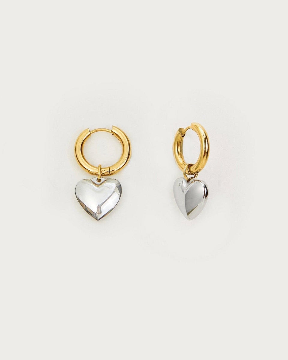 Audrey Heart Earrings
| En Route Jewelry | En Route Jewelry - Discover the exquisite charm of Audrey Heart Earrings, a captivating blend of mixed metals. These stunning jewelry pieces exude elegance and sophistication, with their intricate design and shimmering details. Crafted with utmost precision, these earrings are the perfect accessory to enhance any outfit. Shop now and add
