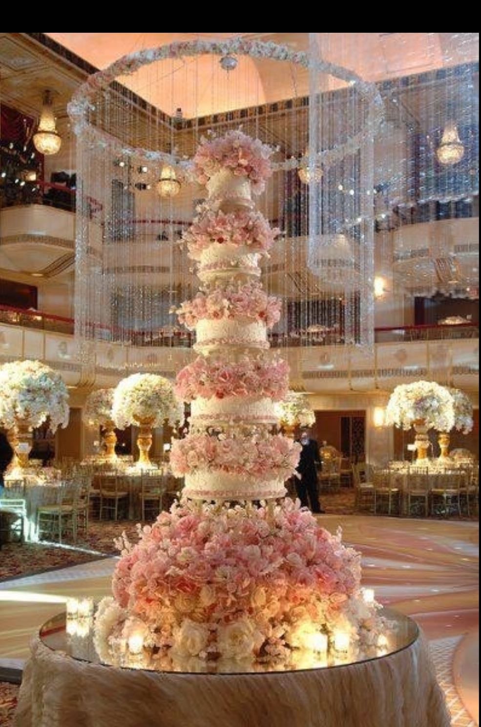 display/fake cake - only the bottom layer is cake (for the first slice) and everything else is fake, and give guests non fancy cake from other room