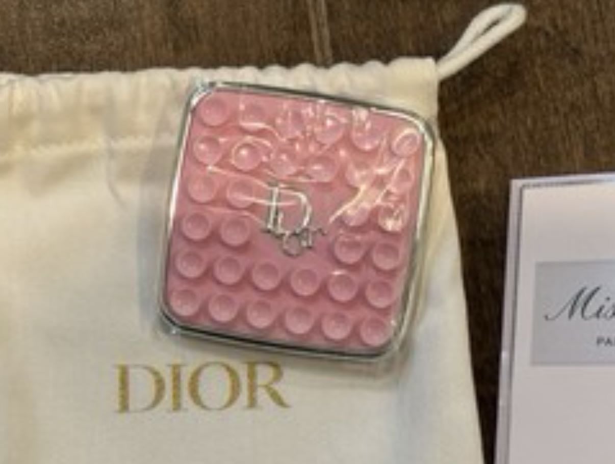 pink Dior‑branded suction phone grip or stand