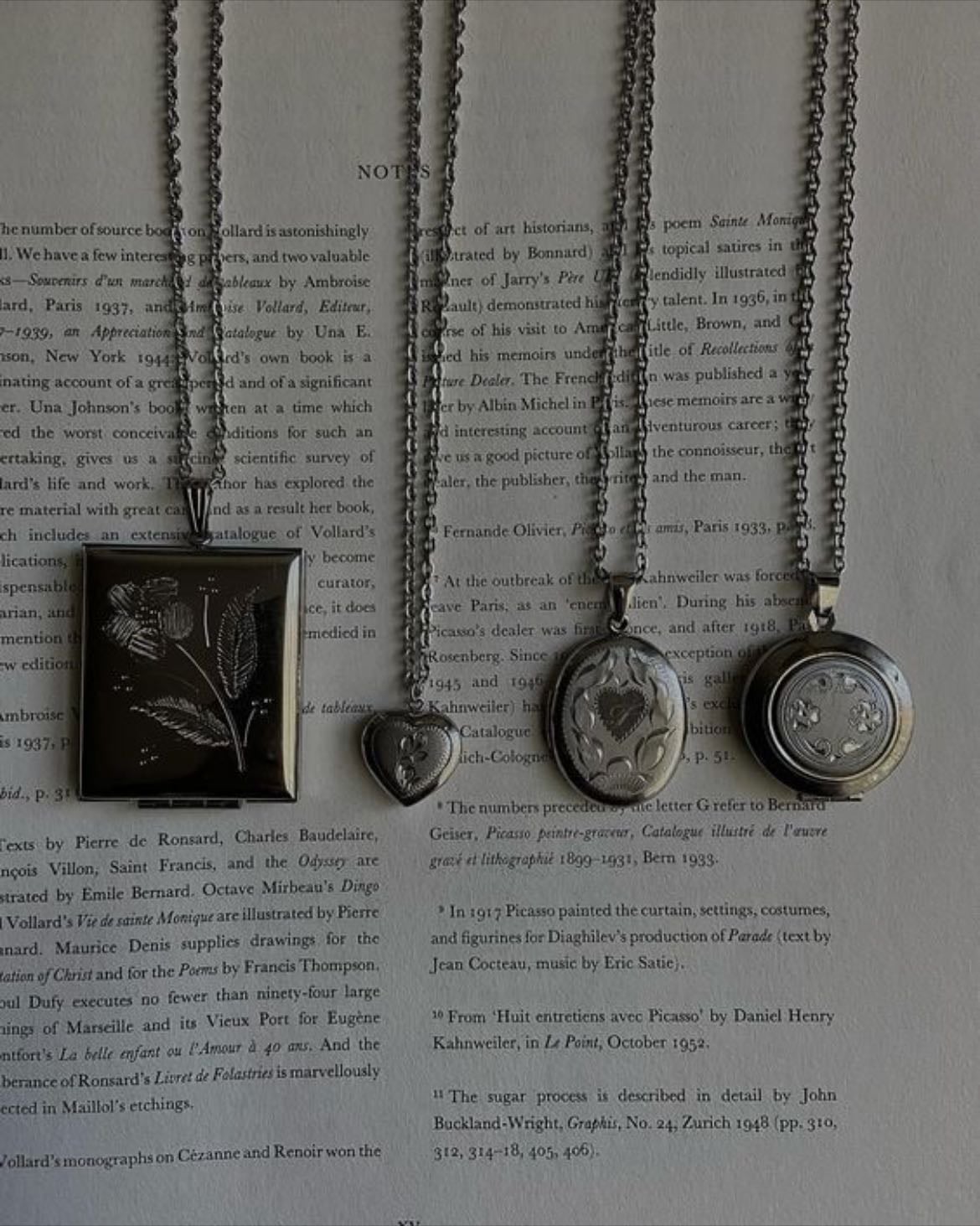 lockets with pictures of people i don't know. - someone loved them once.