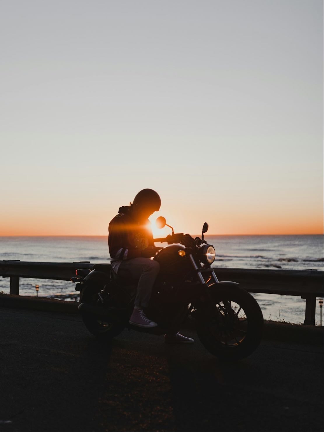 Ride a motorcycle along a coast somewhere
