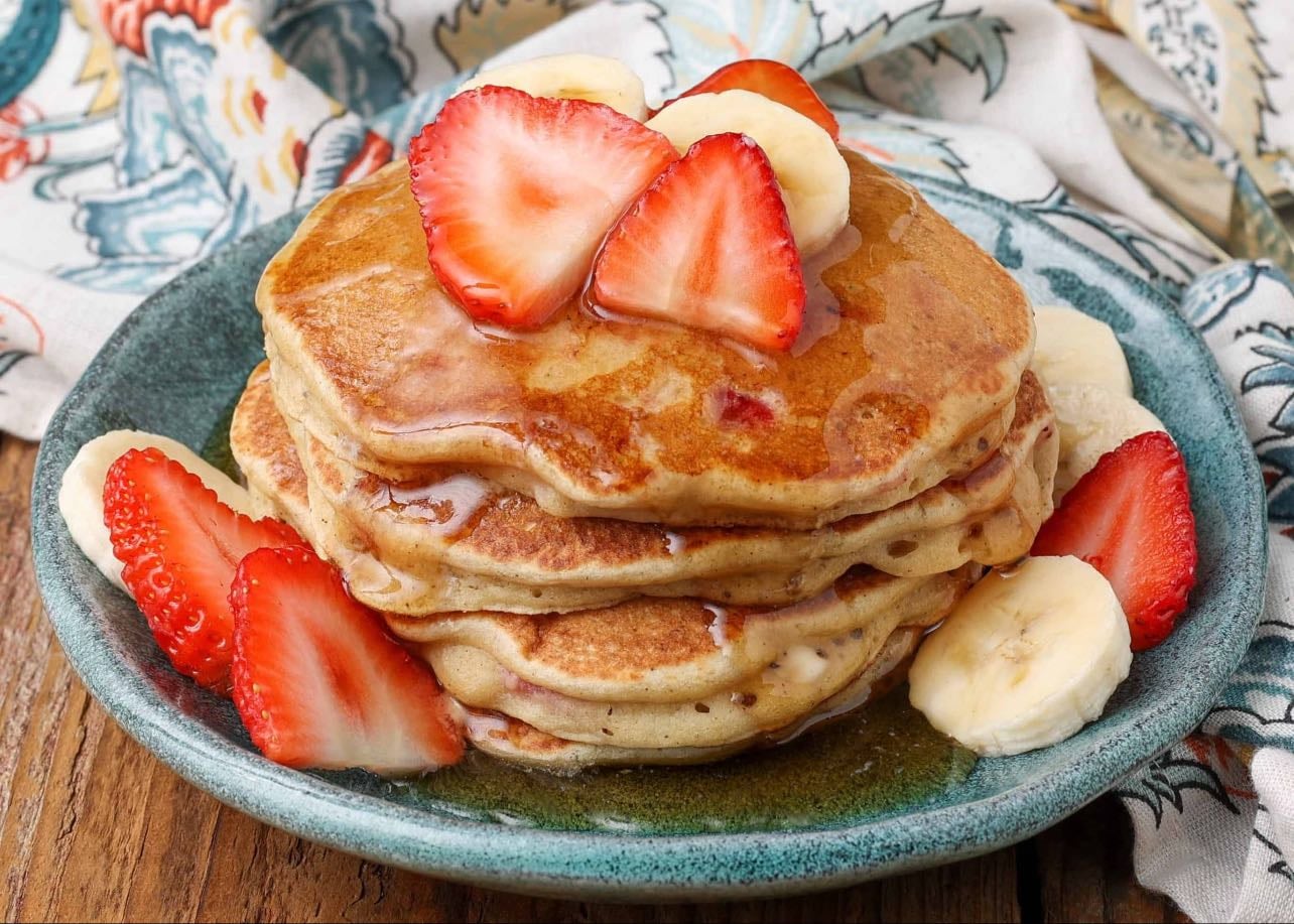 Banana pancakes - Pancakes: 2 mashed bananas, 2 eggs, dash of cinnamon, 1 tablespoon of Greek yogurt, splash of vanilla, 2 tablespoons of flour. Toppings: Fruit and honey