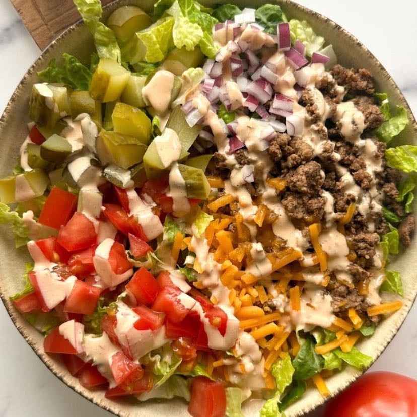 Cheeseburger inspired salad - Lettuce base, chopped tomato, pickles, ground beef, shredded low fat cheese and yogurt+chipotle dressing