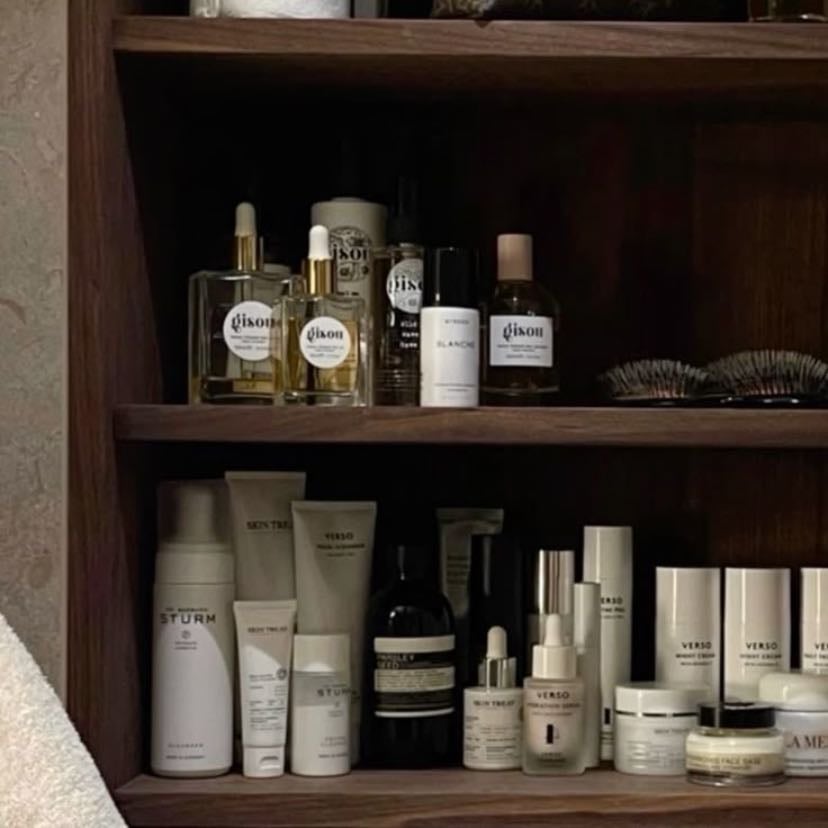 a stocked toiletries cabinet - expensive skin care and beauty products