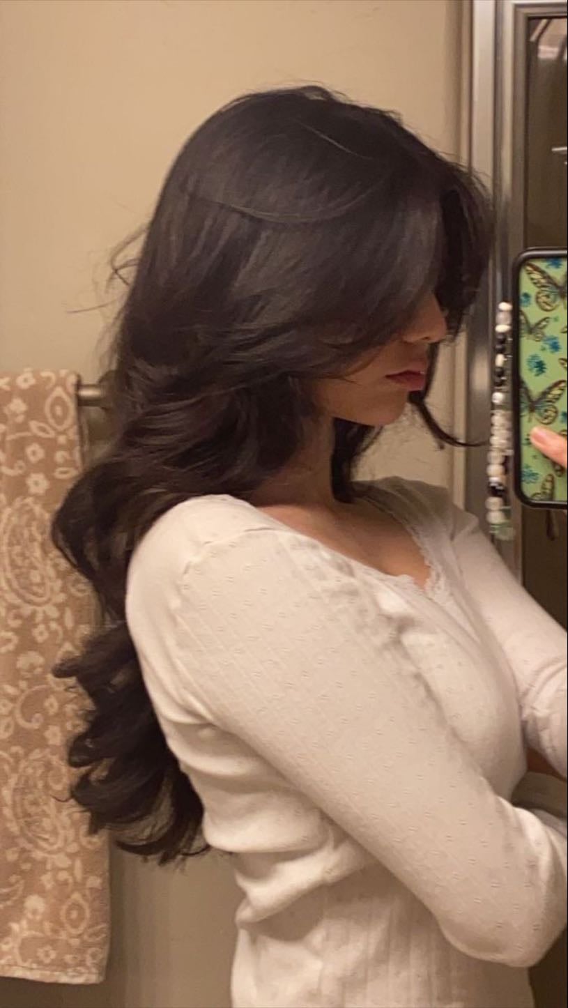 Curtain bangs and long layered wavy hair