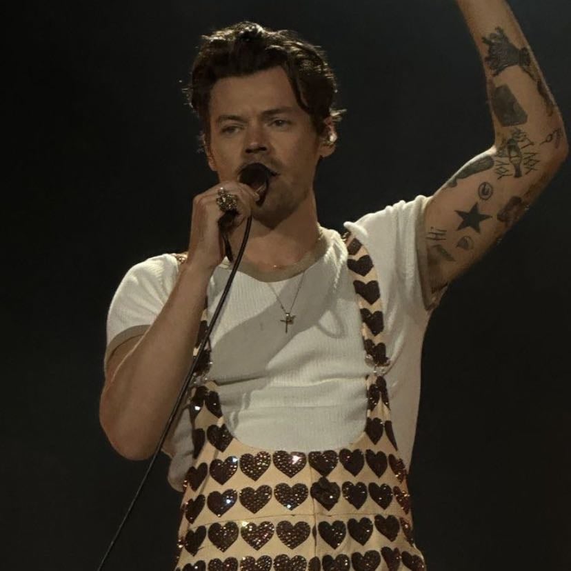 london 06/13/2023 - Beige overalls with brown sparkly hearts, white T-shirt, red satellite stompers