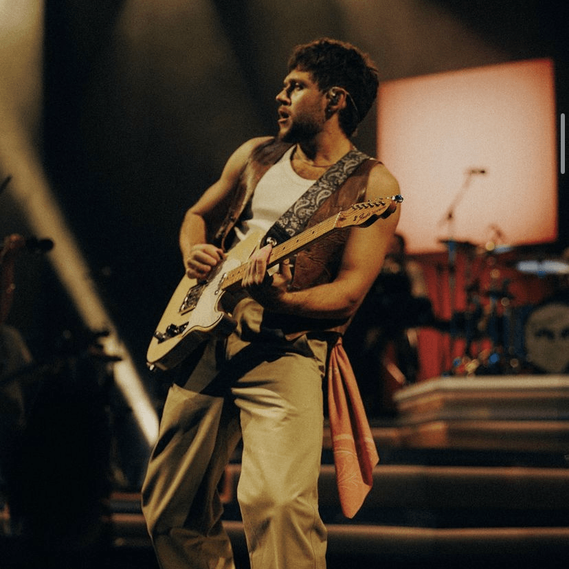 #49 — clarkston - tan pants, white tank top, brown leather vest, orange patterned handkerchief, dress shoes