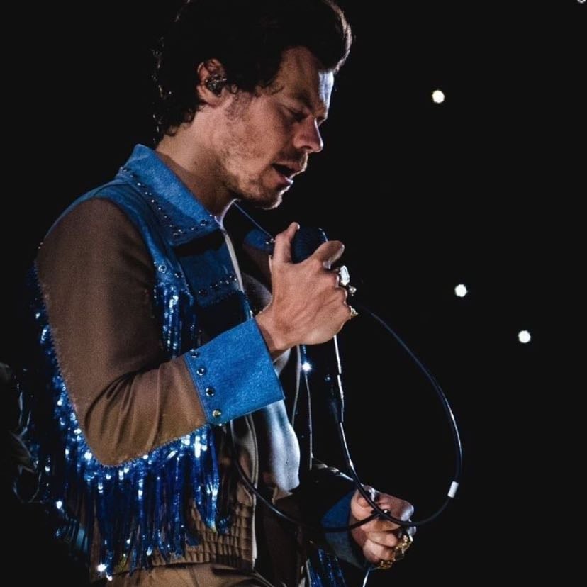 la 10/28/2022 - blue cowboy vest w/ brown sleeves and blue metallic tassels down the arms, brown pants, black satellite stompers