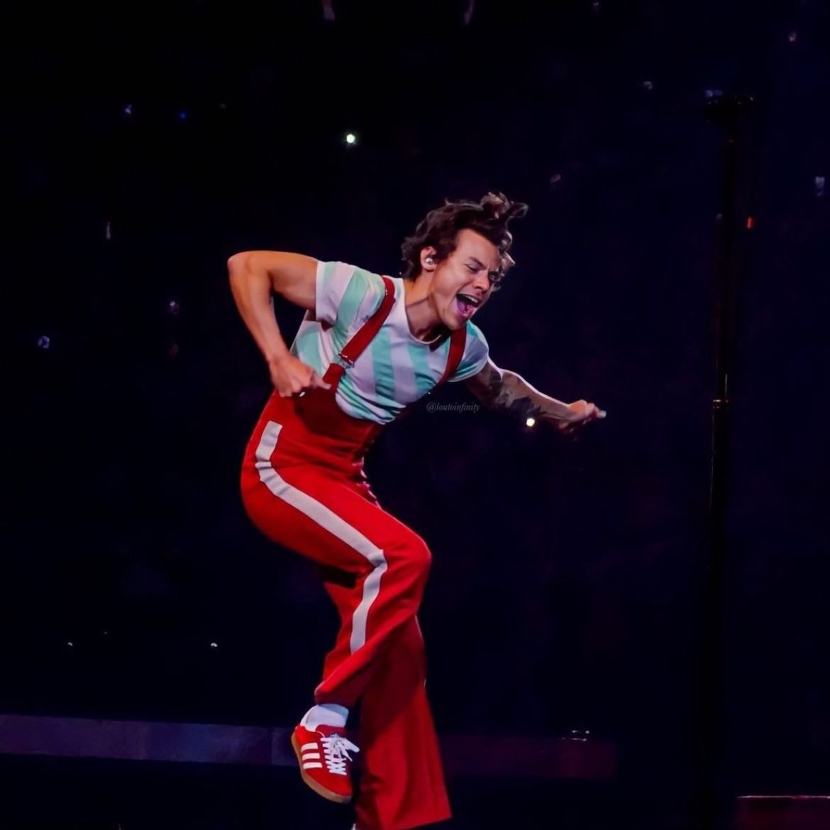 nyc 09/03/2022 - Red overall body suit with a white strip, teal and white striped T-shirt, red satellite stompers