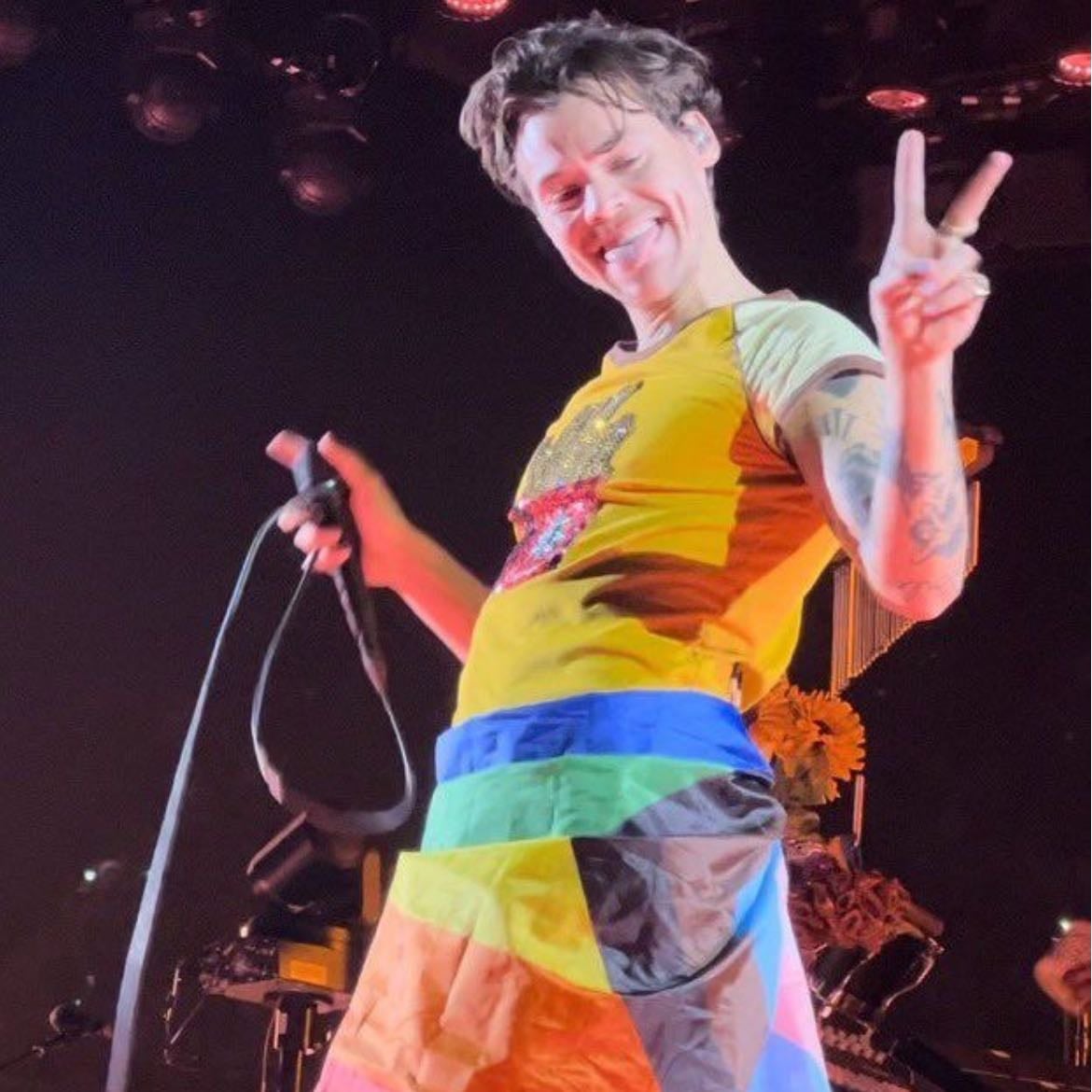 la 01/26/2023 - Beige leather pants (ripped), yellow T-shirt with sparkly fries on the front, dark green satellite stompers