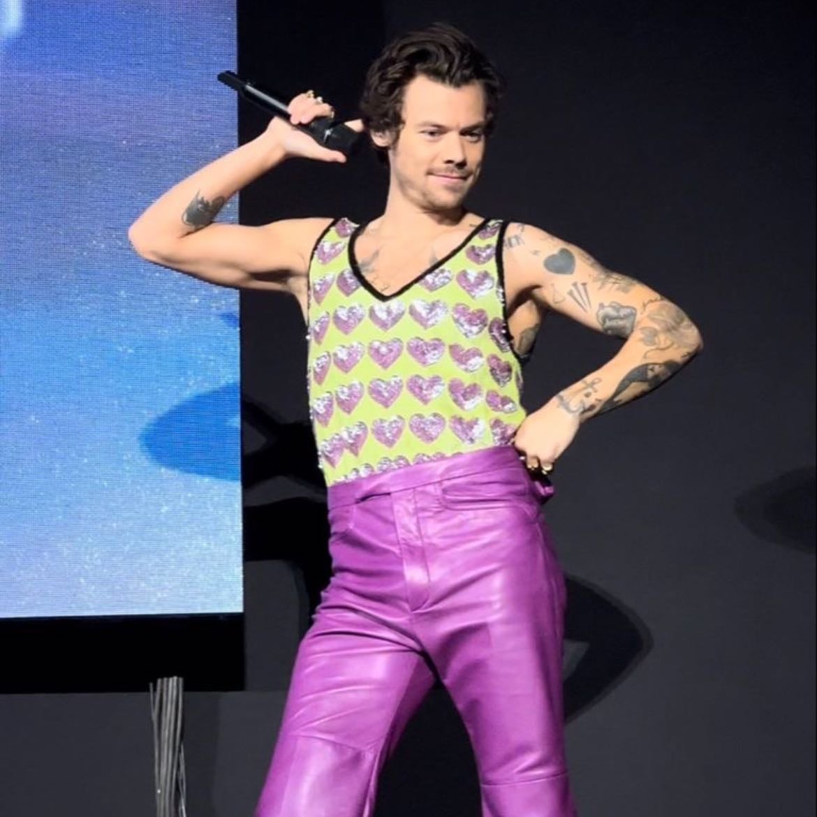 sao paula 12/14/2022 - Purple leather pants, neon yellowish green tank top with sparkly purple hearts, purple satellite stompers