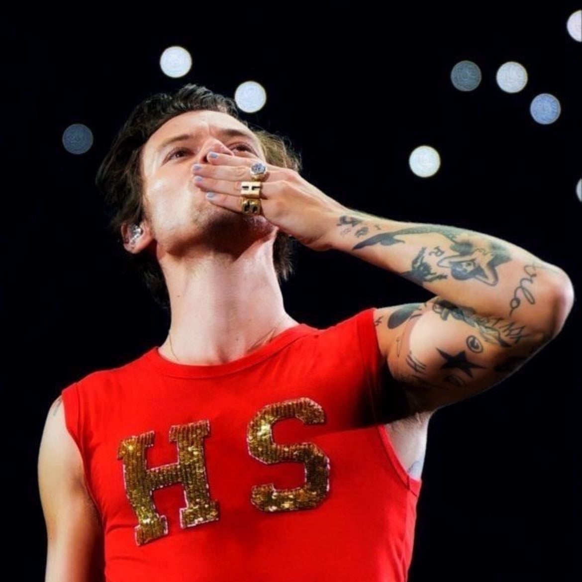 toronto 08/15/2022 - Beige leather pants with sequins on the side, red tank top with H S with gold sequins, Red satellite stompers