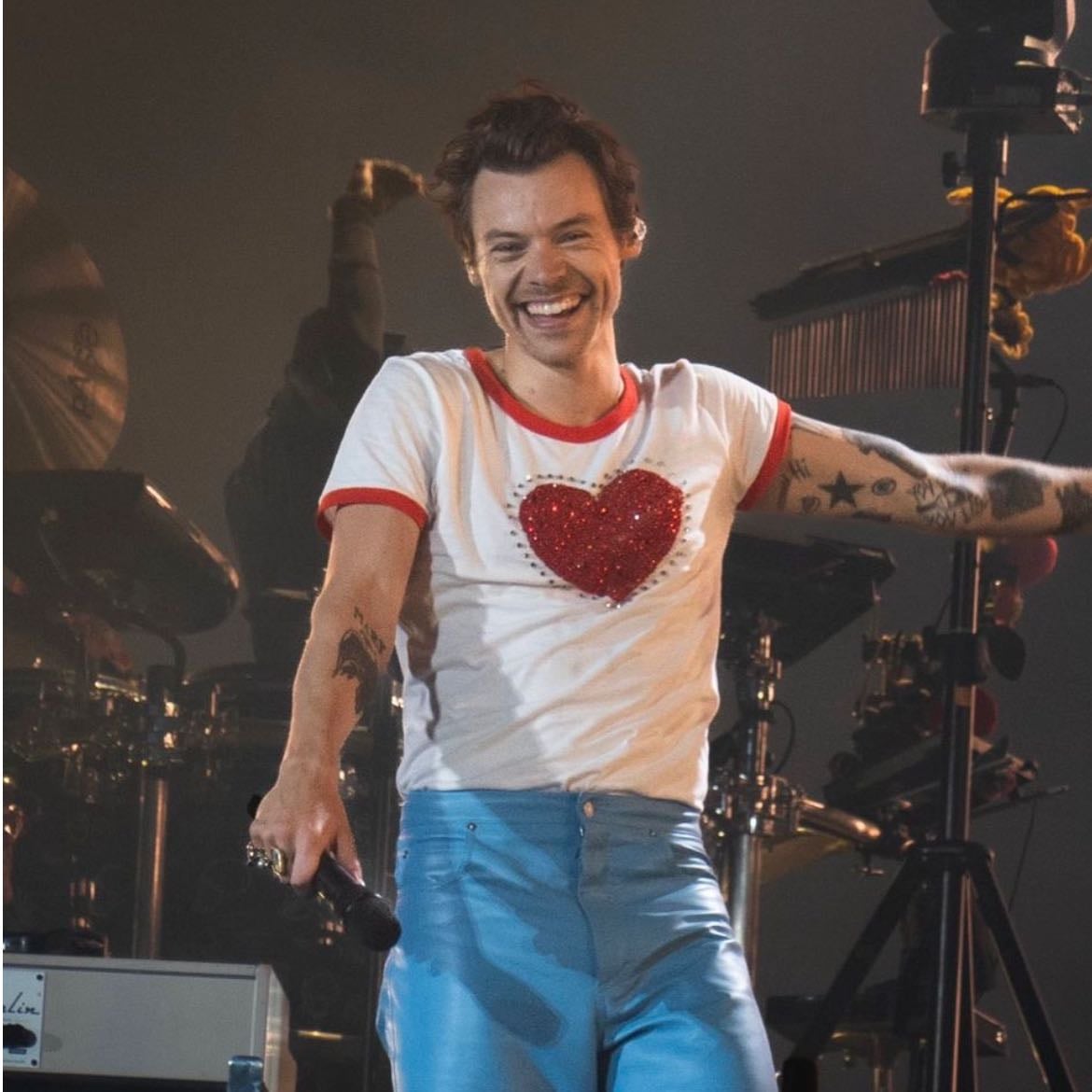 stockholm 06/29/2022 - Blue leather pants, white shirt with a glittery red heart, red satellite stompers