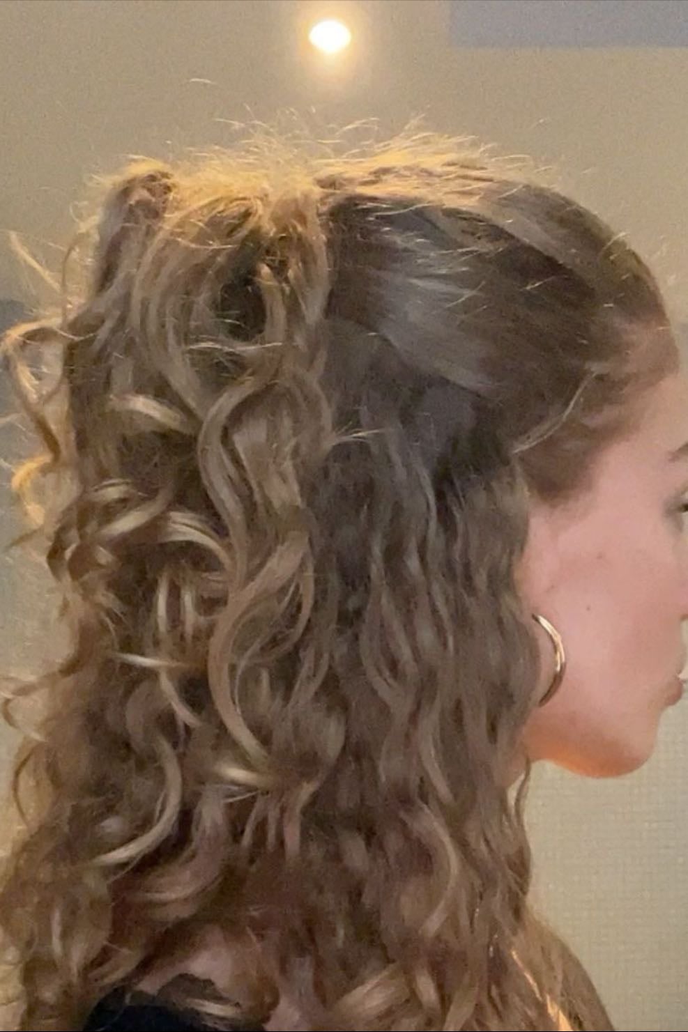 slicked half up down curly