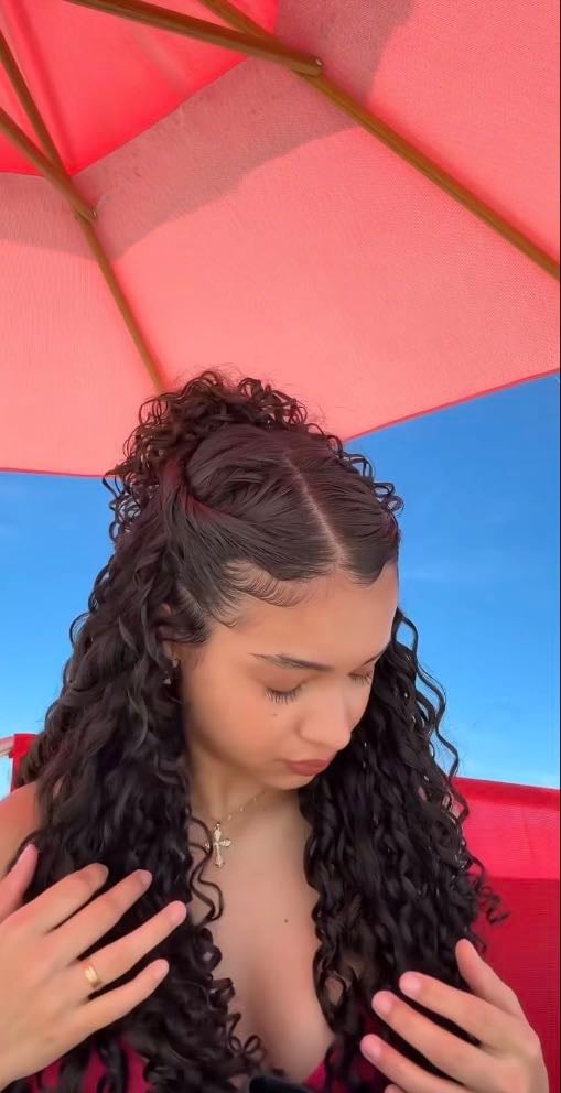 Sleek middle part, side twists and messy bun