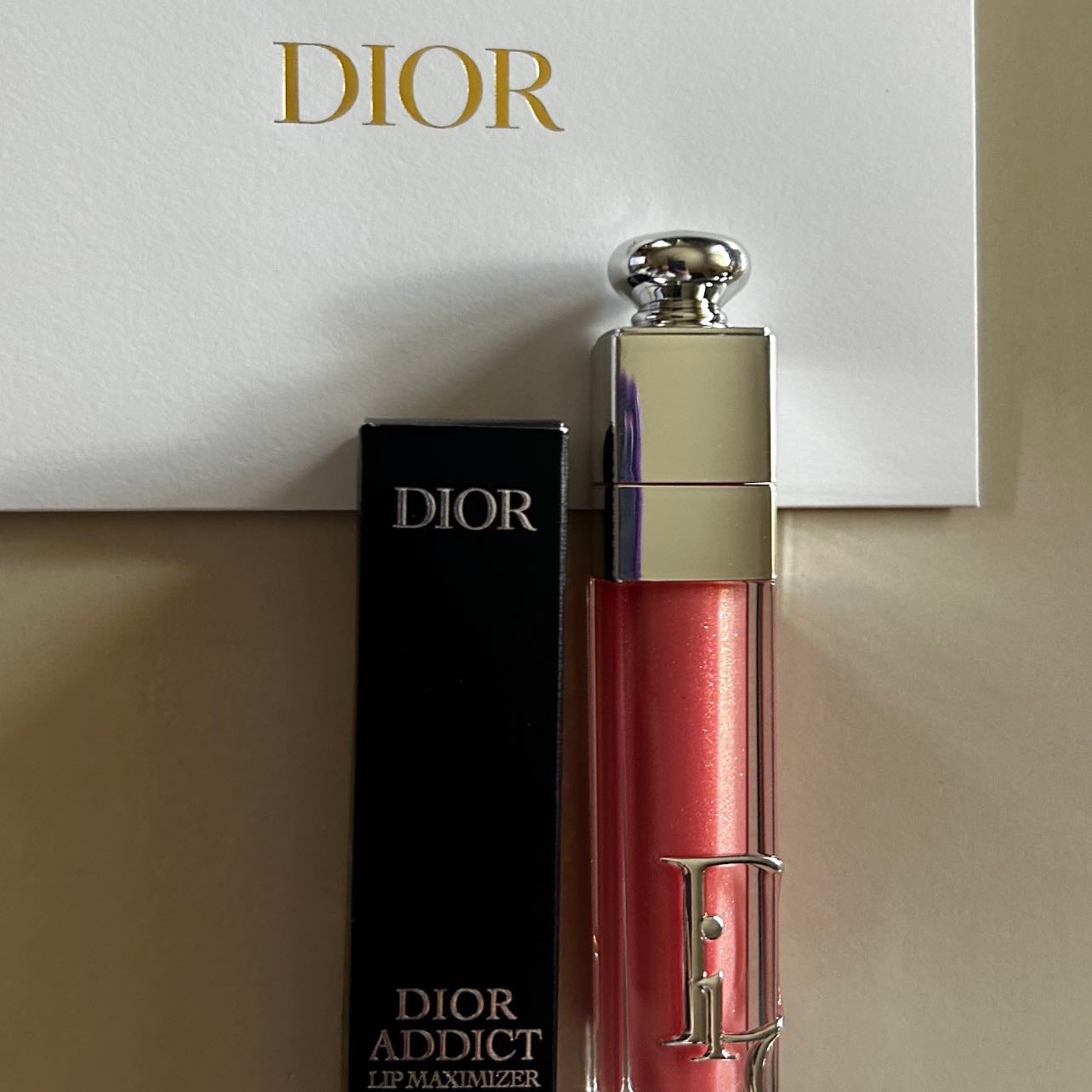 DIOR ADDICT LIP MAXIMIZER🎀 - It has a shade of pastel pink with golden and silver glitter, a great mix