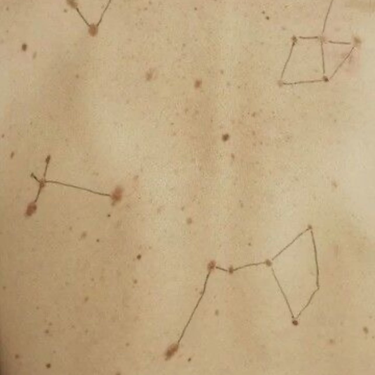 mini constellations - there is a theory that the moles peppering your skin are where you have been kissed in a past life. there is one marking your cheek.