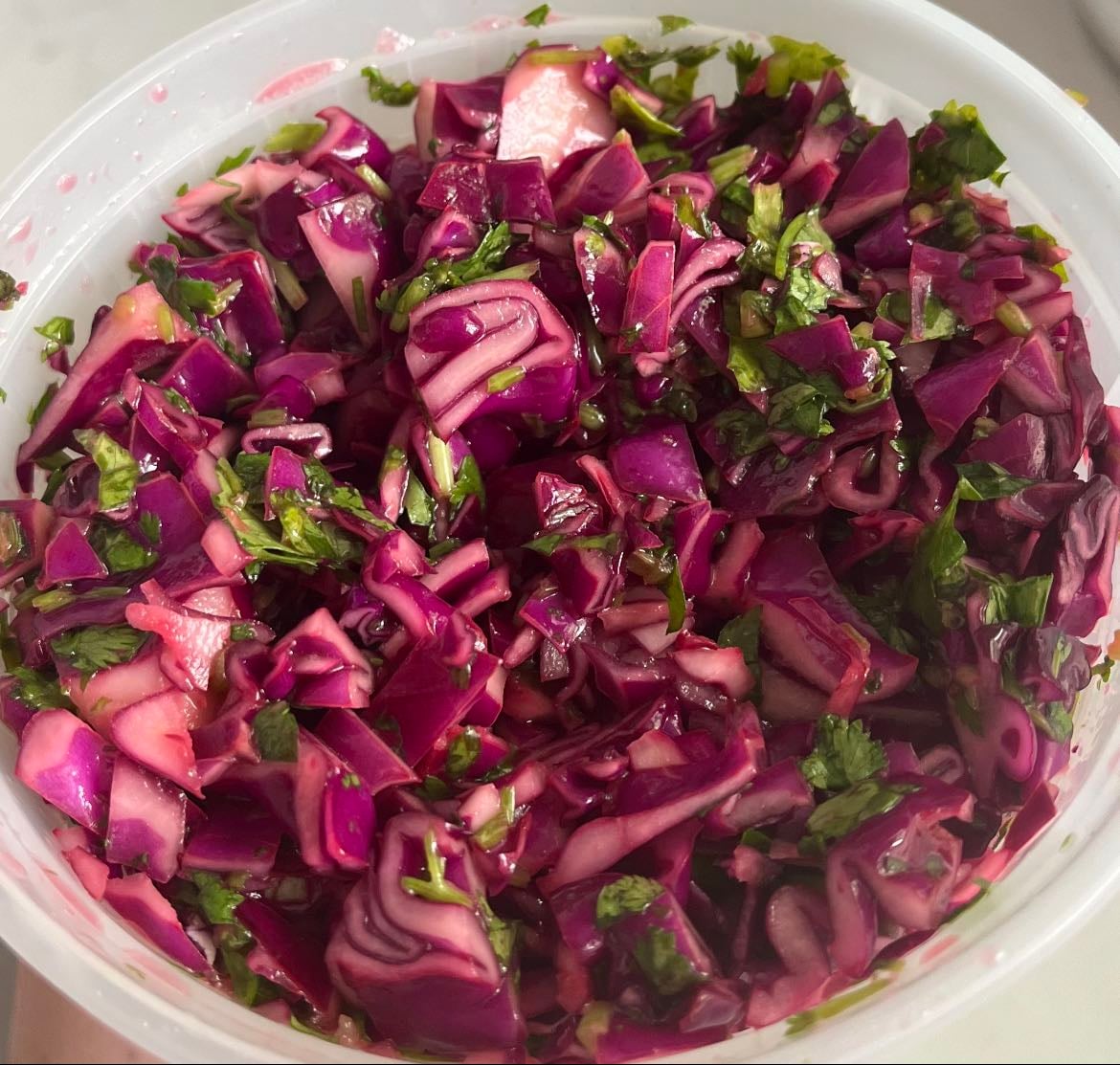 Red cabbage slaw - Chopped and mixed red cabbage, lime juice, cilantro, olive oil, salt.