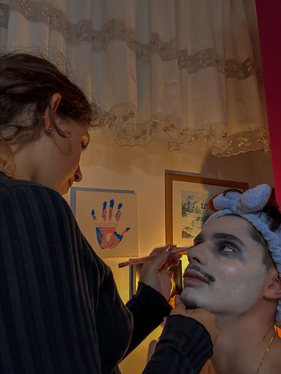 Doing his makeup